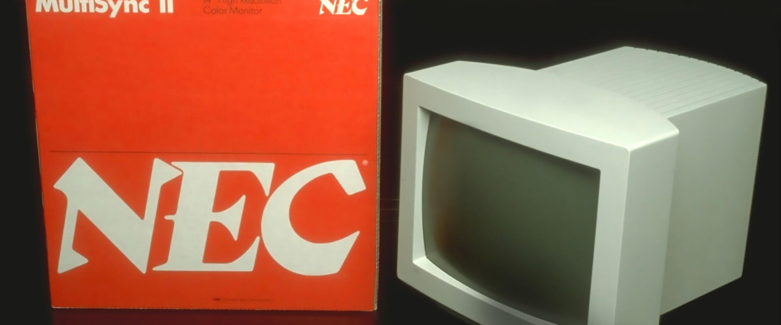 A vintage NEC MultiSync II 14" CRT monitor next to its red and white packaging box labeled "NEC."
