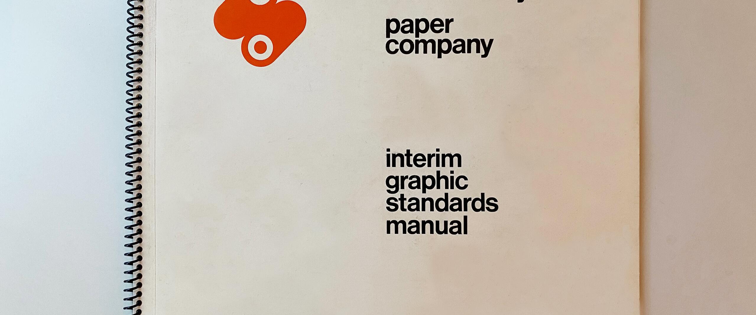 Spiral-bound graphic standards manual with "mondi valley paper company" text and an orange abstract logo on a beige background.