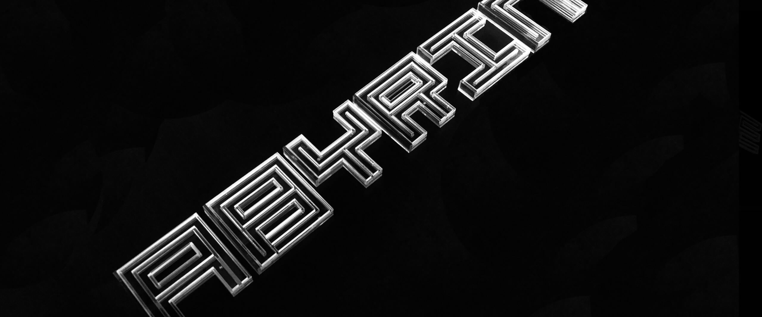 Text "LABYRINTH" in silver, stylized with geometric, maze-like lines on a black background.