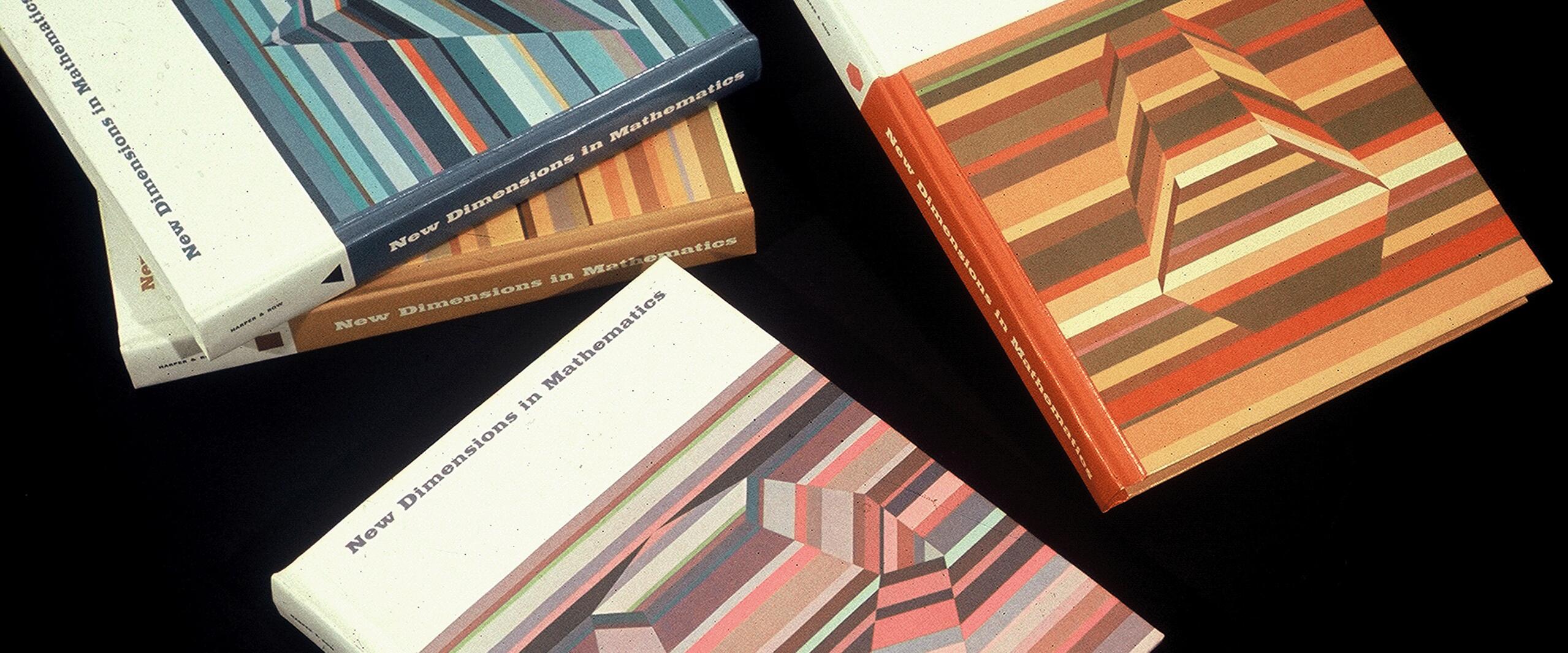 Four colorful math textbooks with geometric patterns on the covers, titled "New Dimensions in Mathematics," are arranged on a black surface.