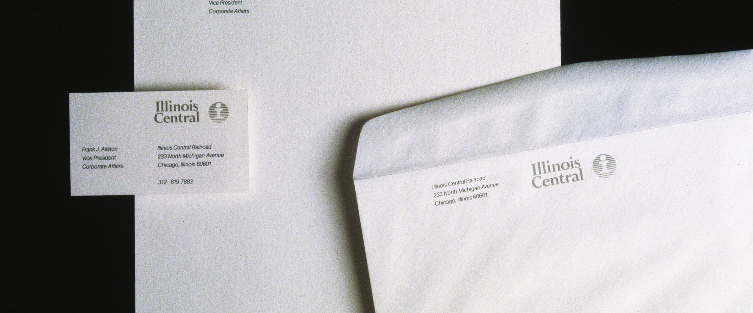 Stationery set on a black background, including a business card, letterhead, and envelope branded with "Illinois Central" logo and contact information.