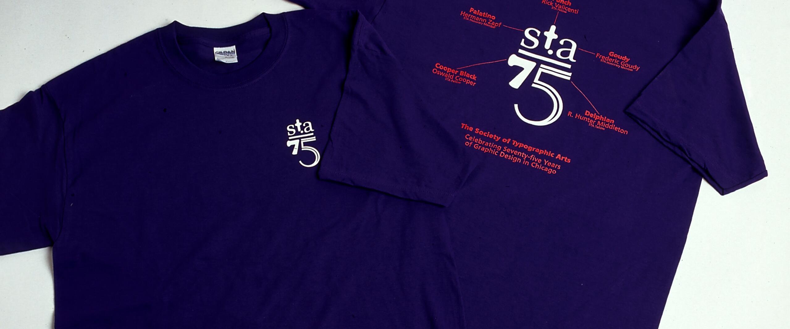 Purple T-shirts with "sta 75" logo. Front shirt shows small logo. Back shirt features larger logo and red text celebrating seventy-five years of graphic design in Chicago.