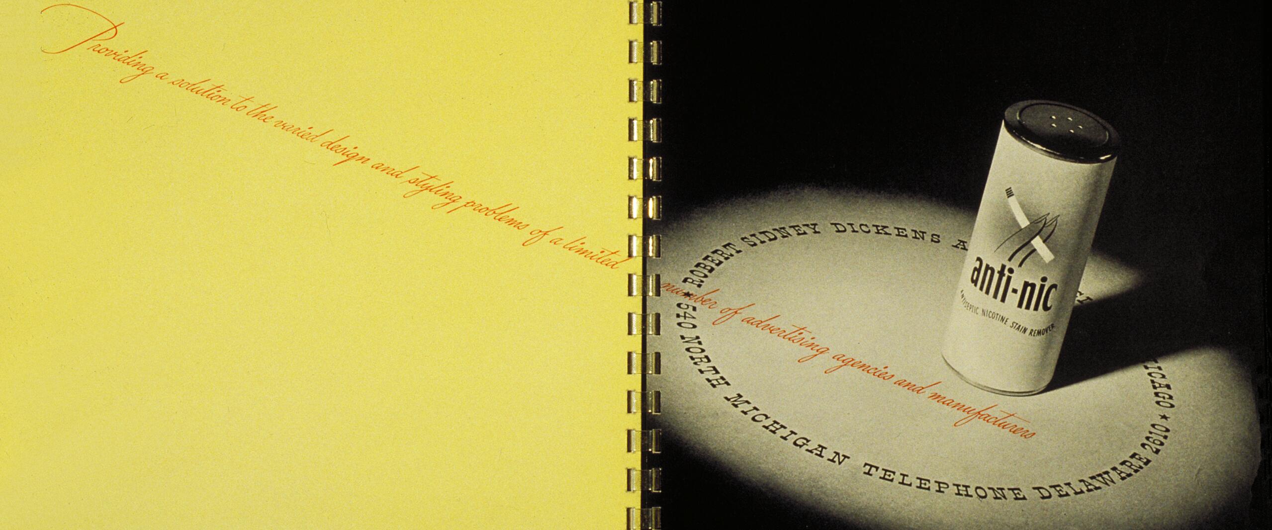 Open book with yellow and black pages; on the black page, a small cylindrical canister labeled "anti-nic" stands upright, casting a shadow. Spiral binding visible in the center.
