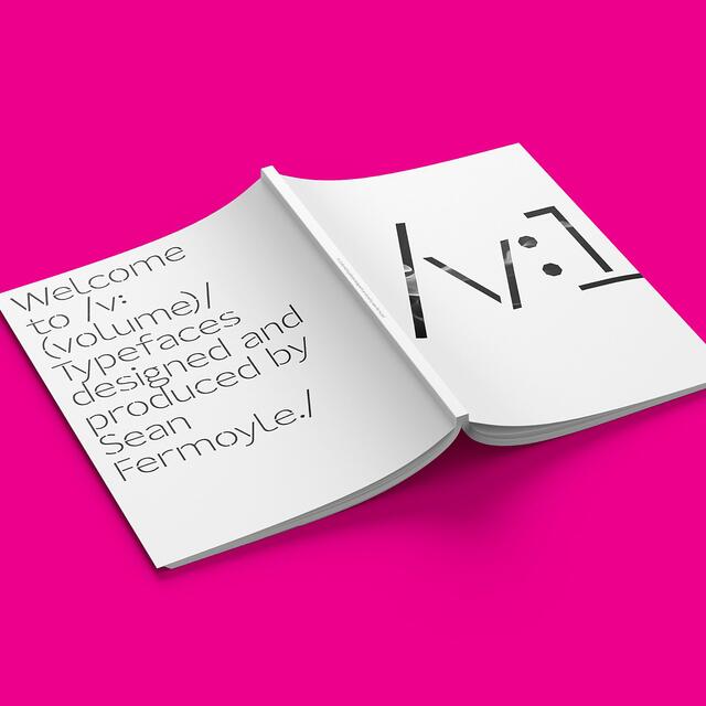 25B-11a_/v: Magazine — Issue 1 - Open book on a bright pink background with modern typography designs and text on the left page_Sean Fermoyle