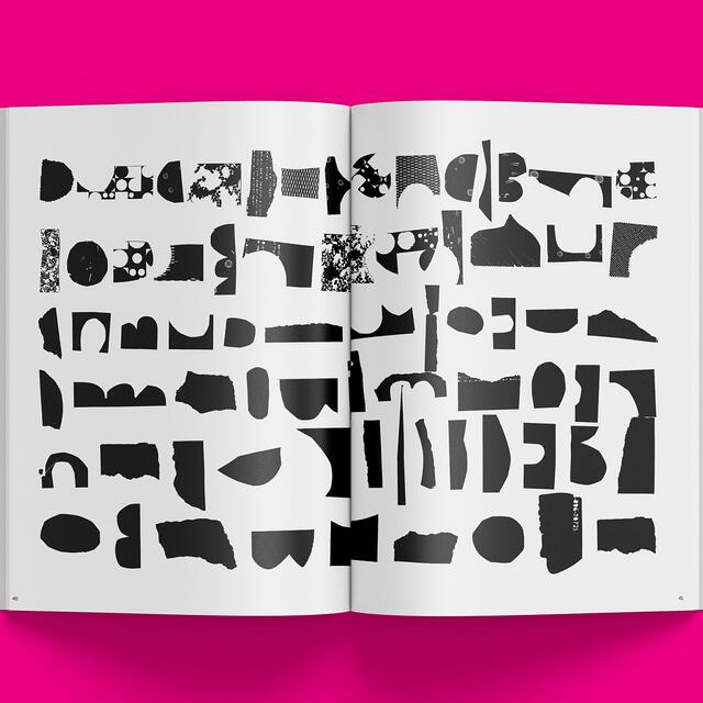 25B-11c_/v: Magazine — Issue 1 - Open magazine with abstract black shapes on a white page, set against a bright pink background_Sean Fermoyle